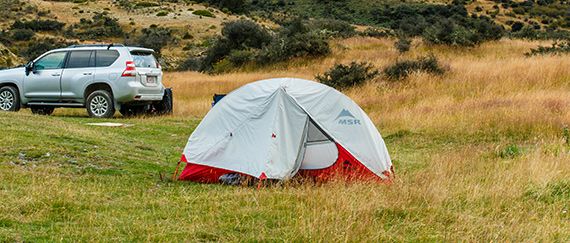 Camping with a backpacking tent on a grassland